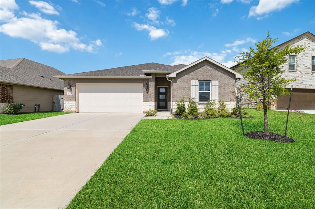 a front view of house with yard and green space