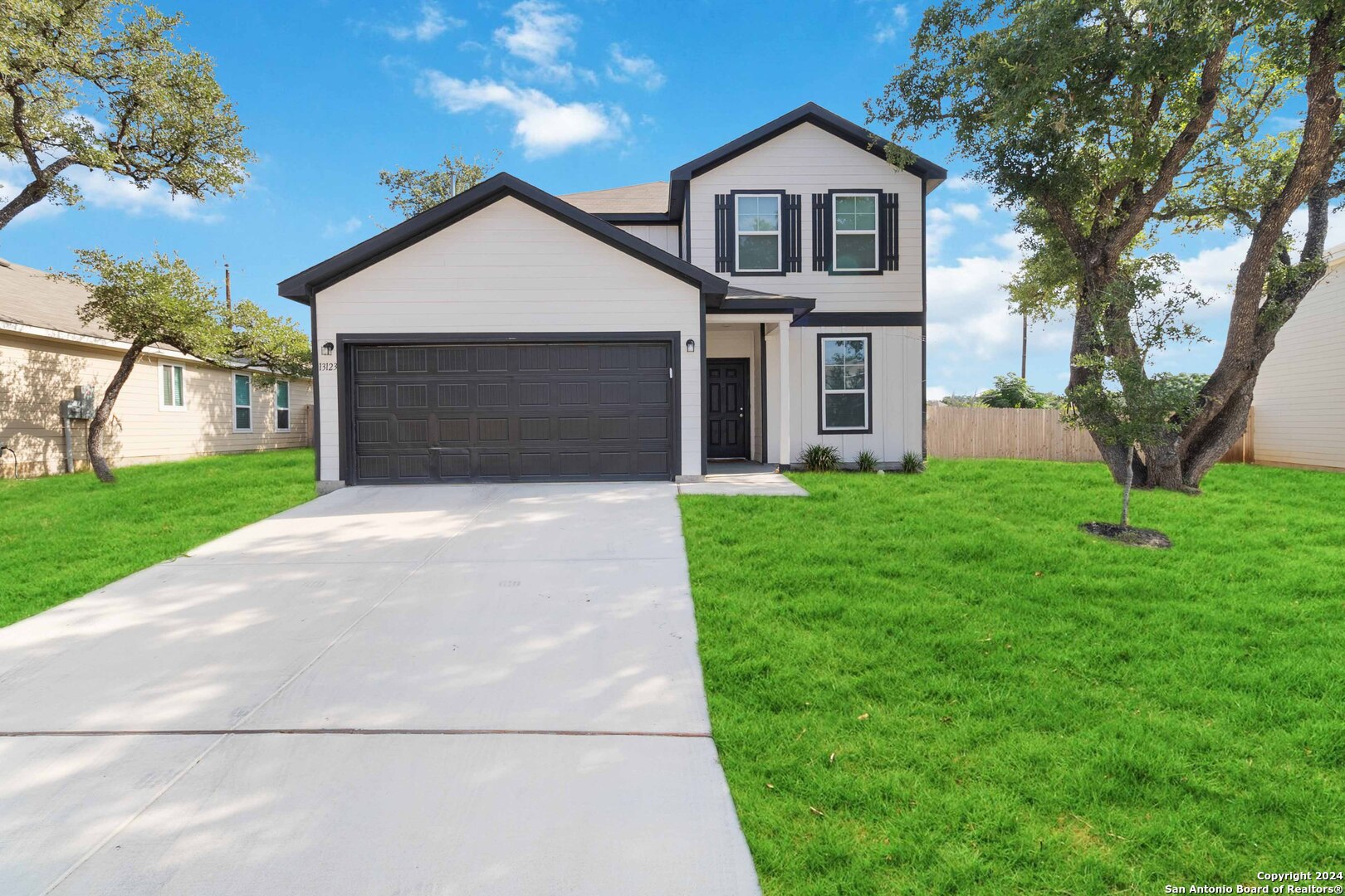 a front view of house with yard and green space