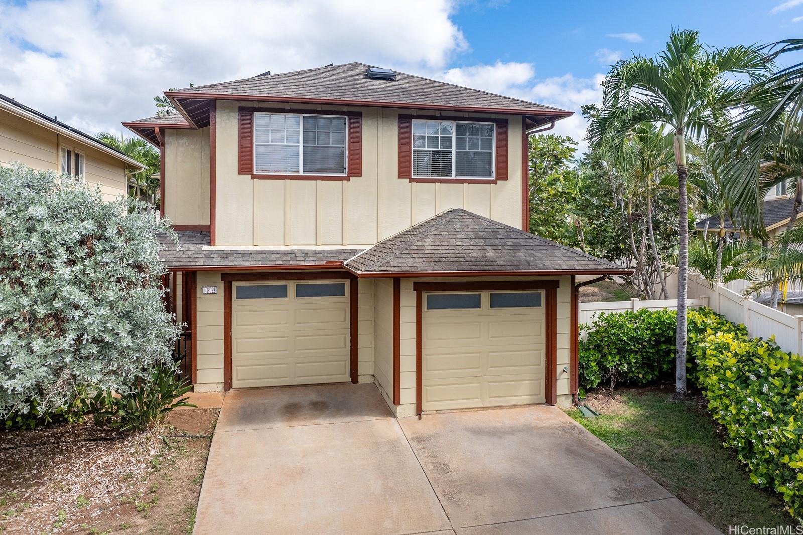 a front view of a house with a garage and a yard