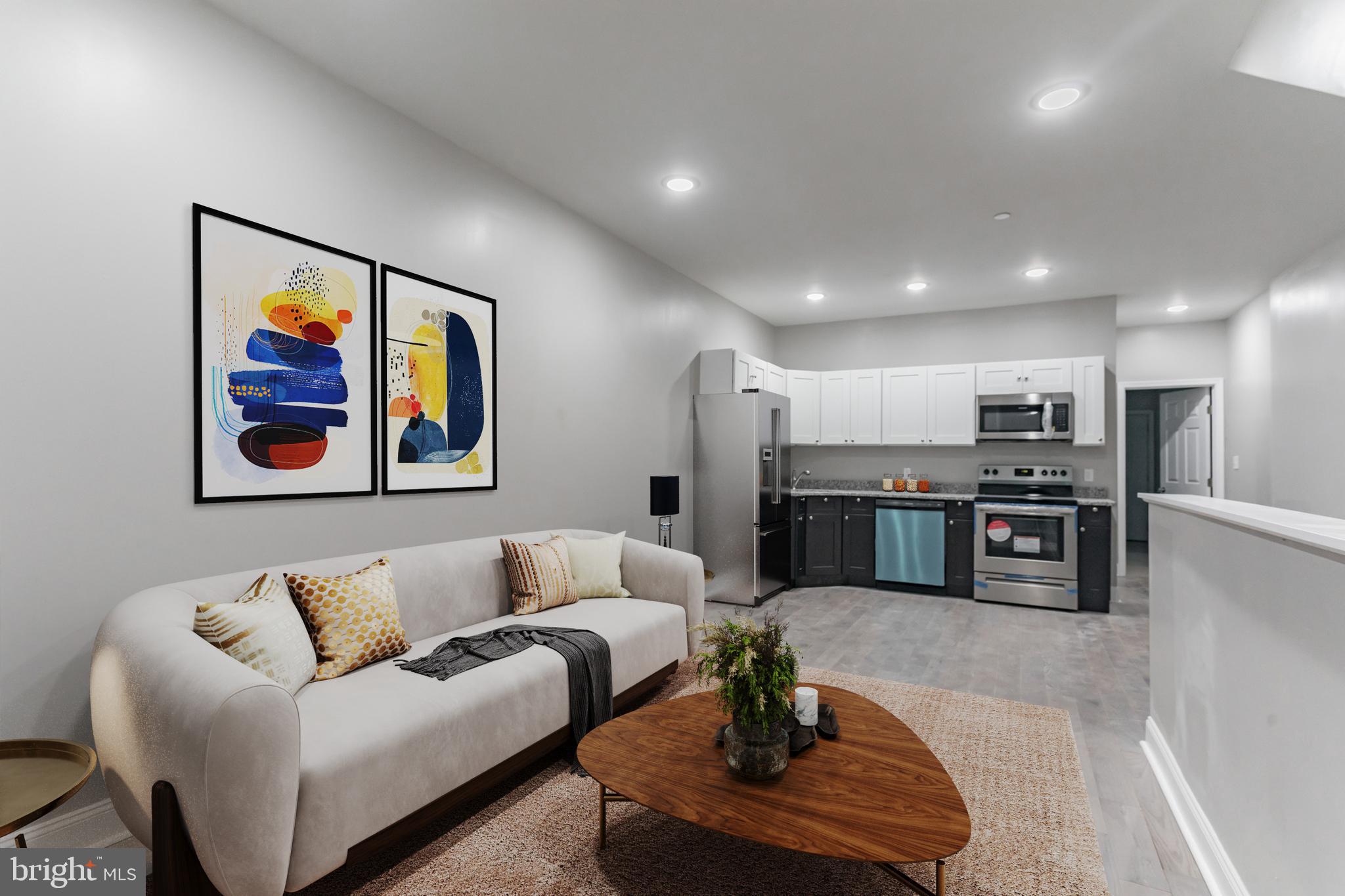 a living room with furniture and kitchen view