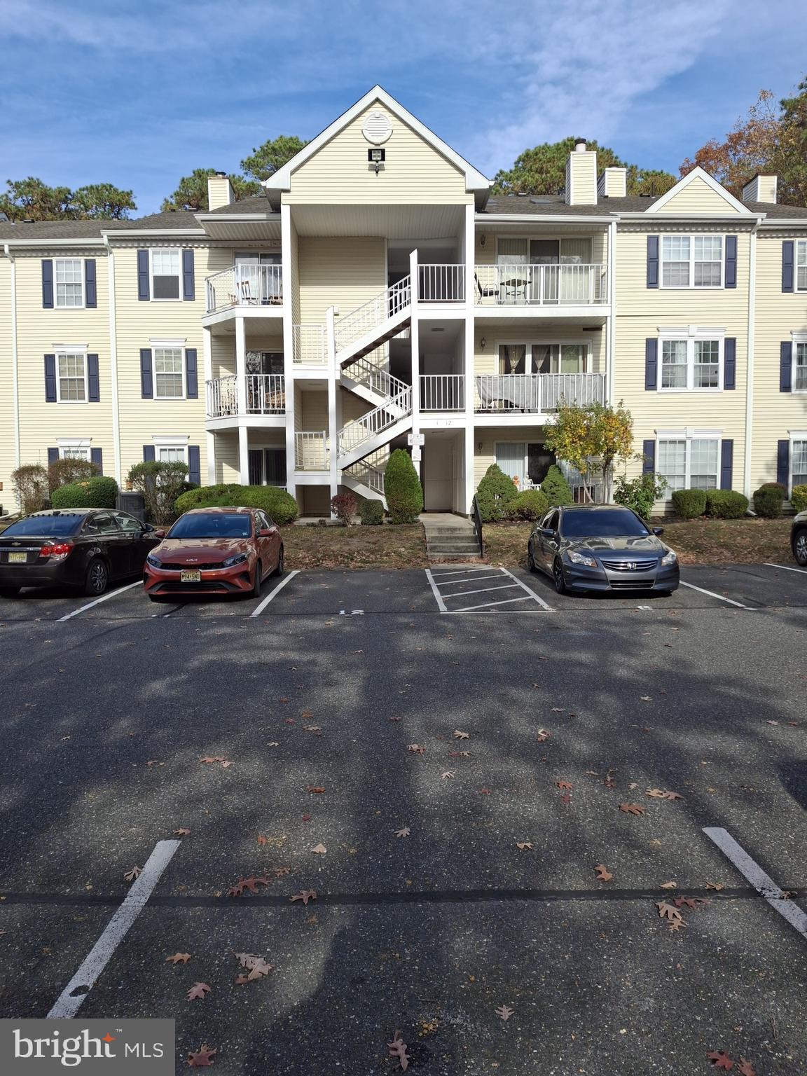 a front view of a building and car parked