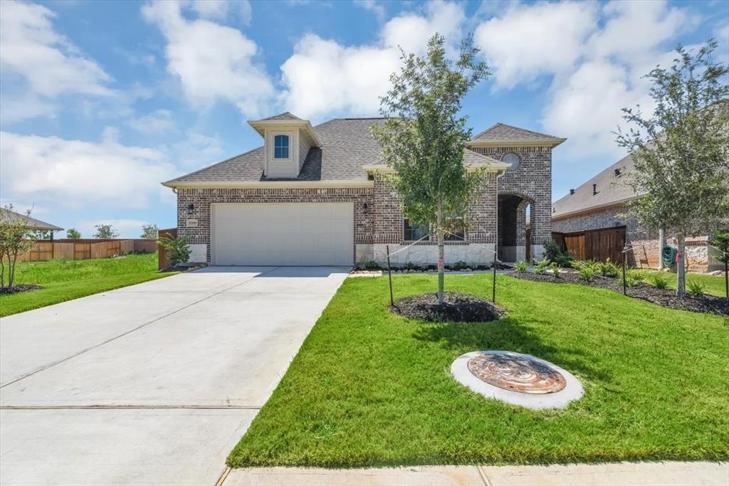 a front view of a house with a yard fire pit and a fountain