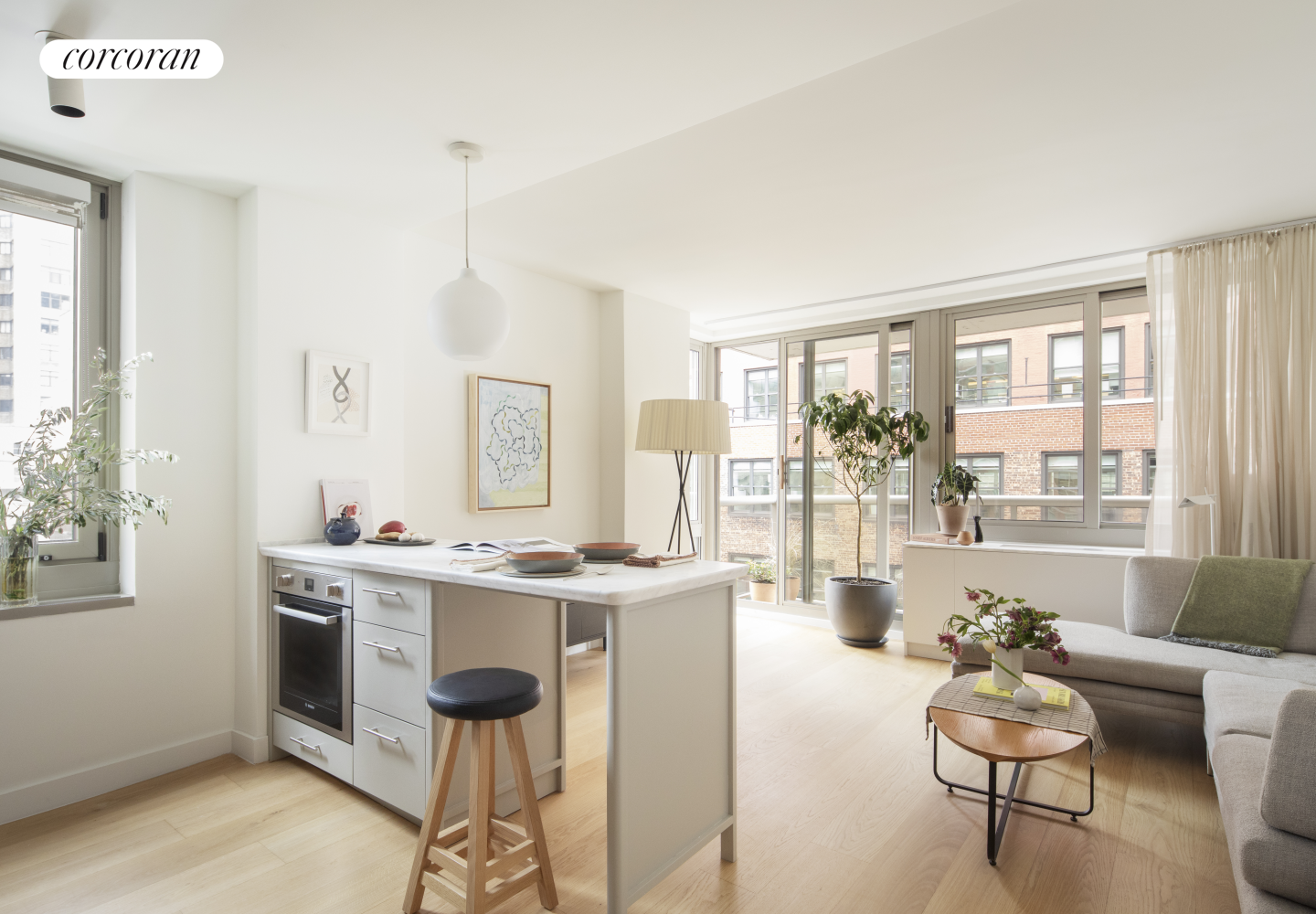 a living room with kitchen island furniture and a large window