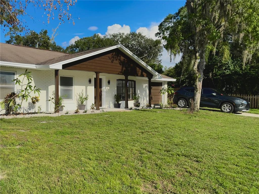 a front view of house with yard and green space