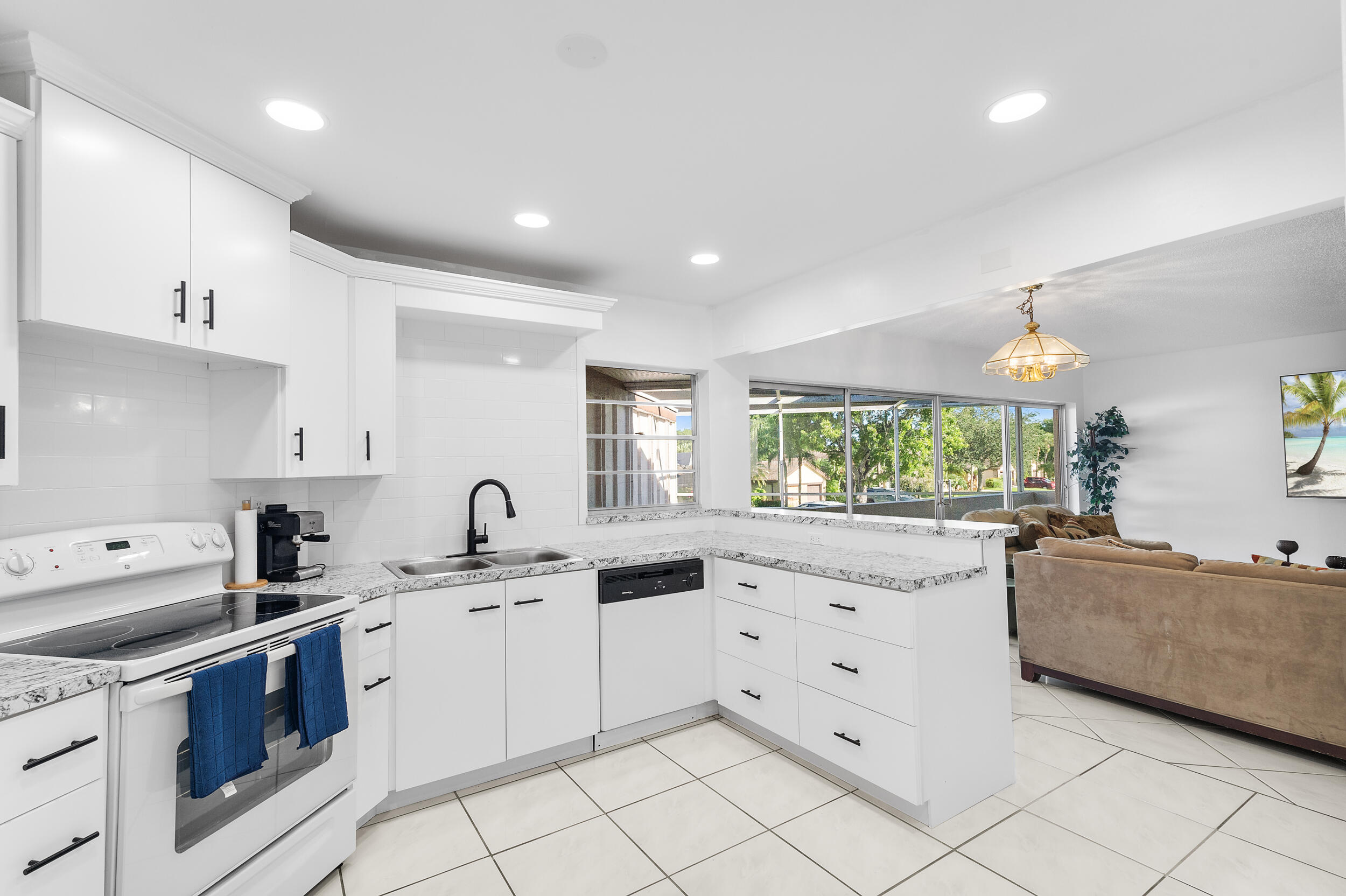 a kitchen that has a sink and a stove in it