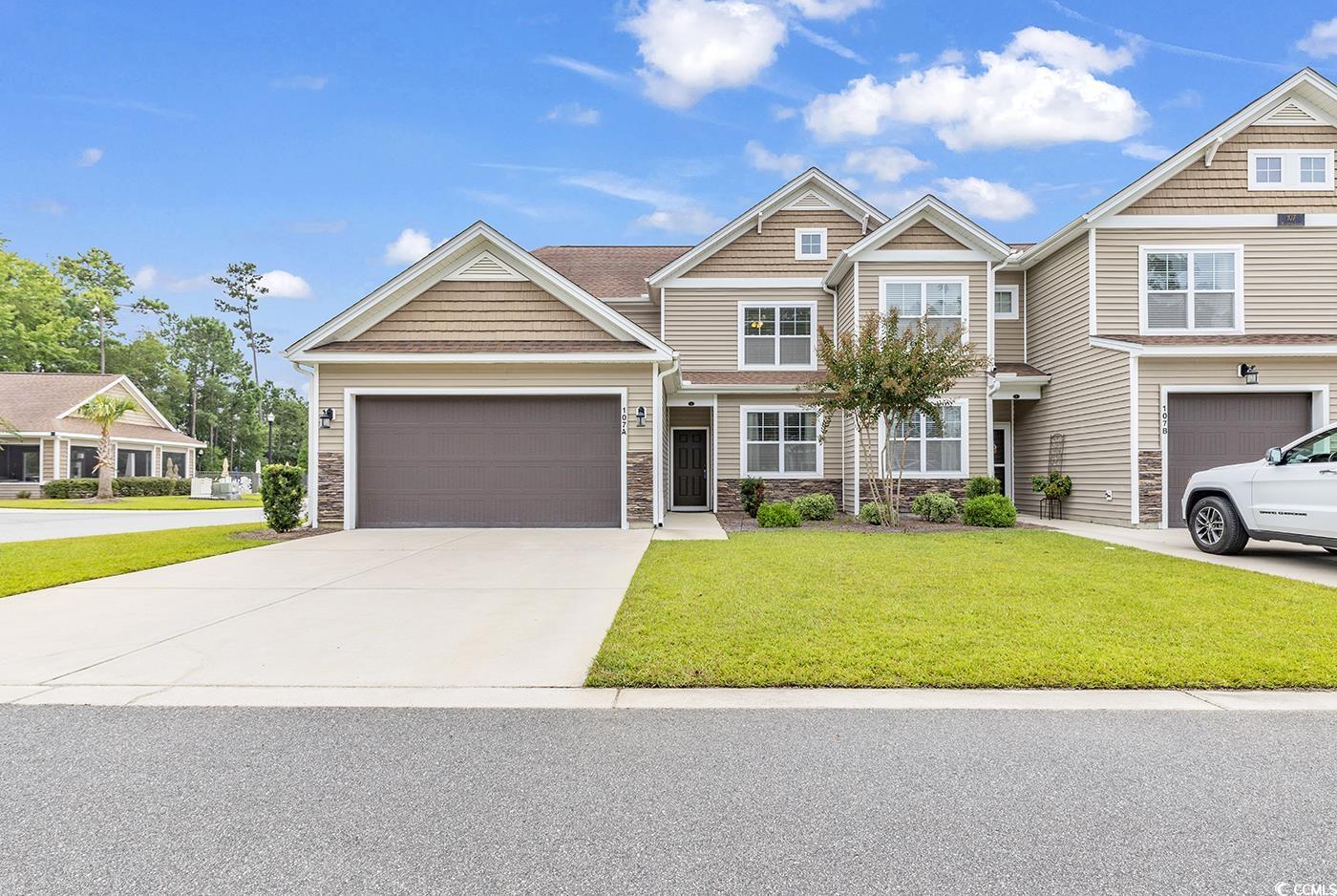 View of front of property featuring a garage and a