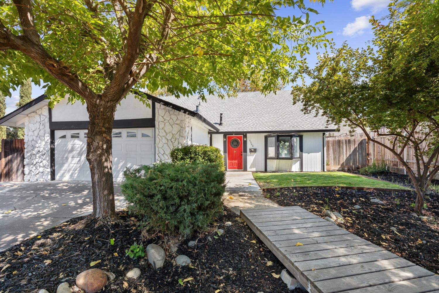 a front view of a house with garden