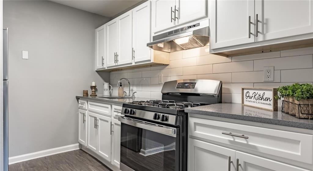 a stove top oven sitting inside of a kitchen