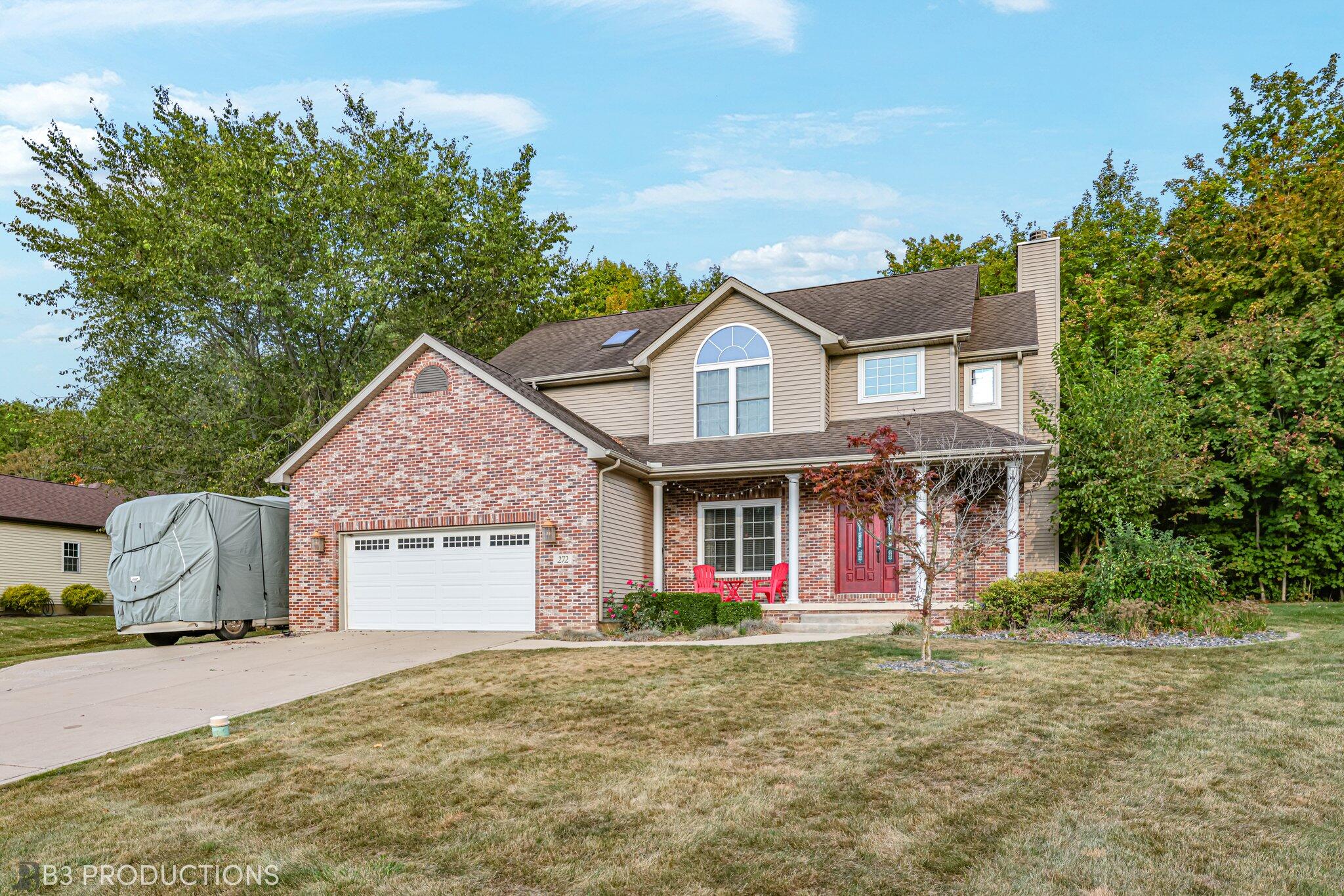 a front view of a house with a yard and garage