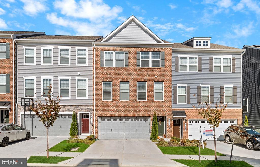 a front view of a residential apartment building with a yard