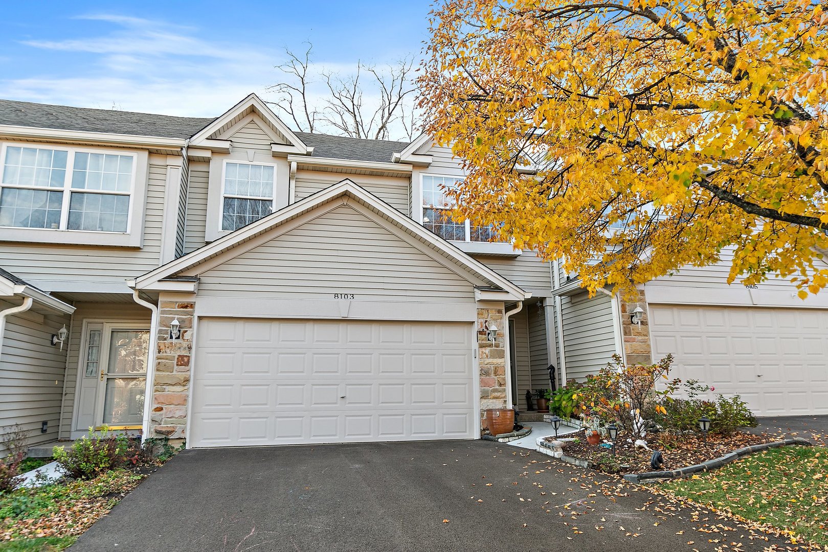 a view of a house with a yard and garage