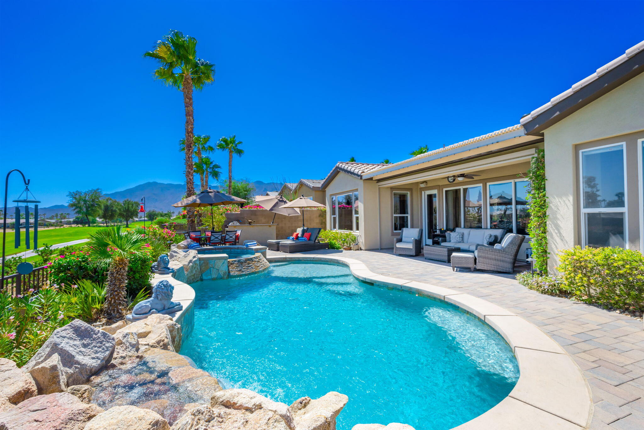 a swimming pool with outdoor seating yard and plants