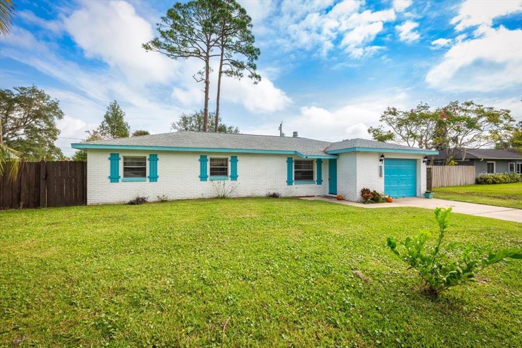 a view of a house with a backyard