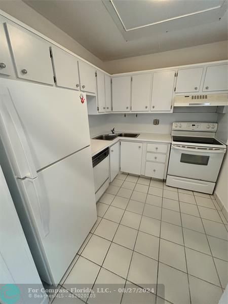 a kitchen with cabinets and white appliances