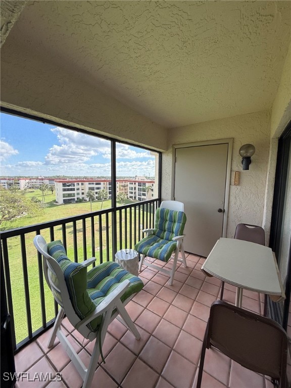 a view of a balcony with furniture