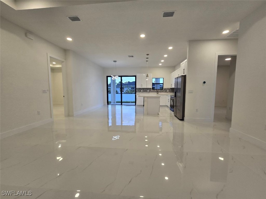 a kitchen with stainless steel appliances a refrigerator and a counter top space