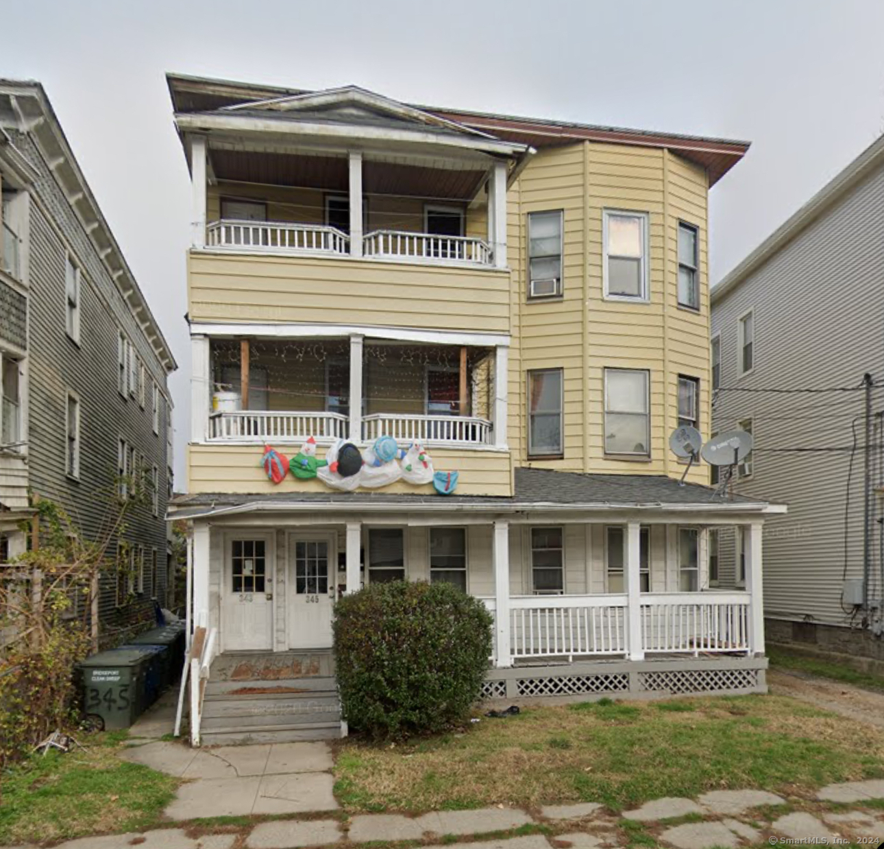 a front view of a house with a wooden deck