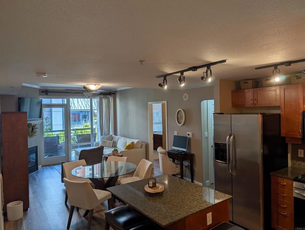 a kitchen with refrigerator and chairs