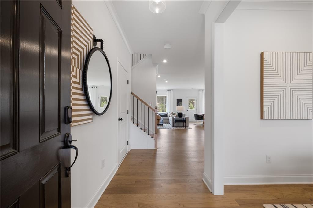 a view of a hallway view with wooden floor and staircase