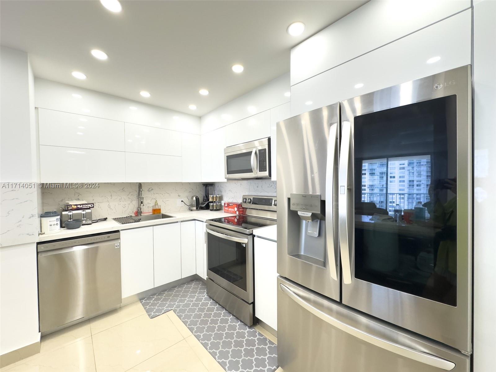 a kitchen with a sink stainless steel appliances and cabinets