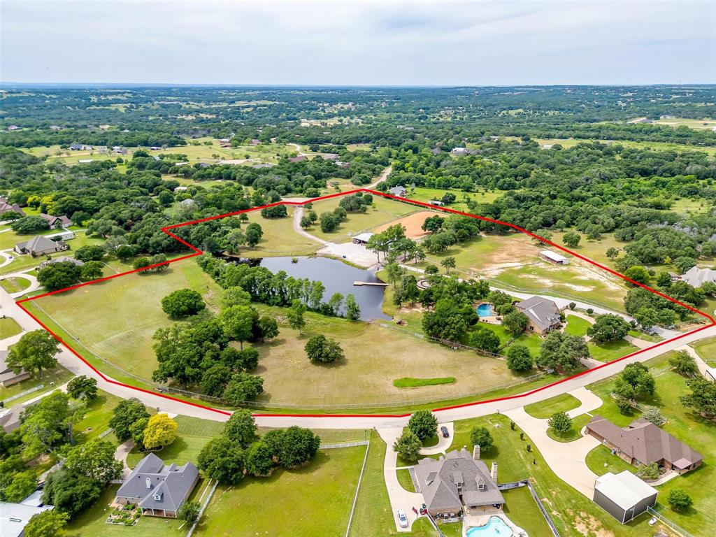 an aerial view of residential houses with outdoor space and river