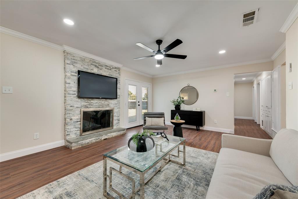 a living room with furniture a fireplace and a flat screen tv