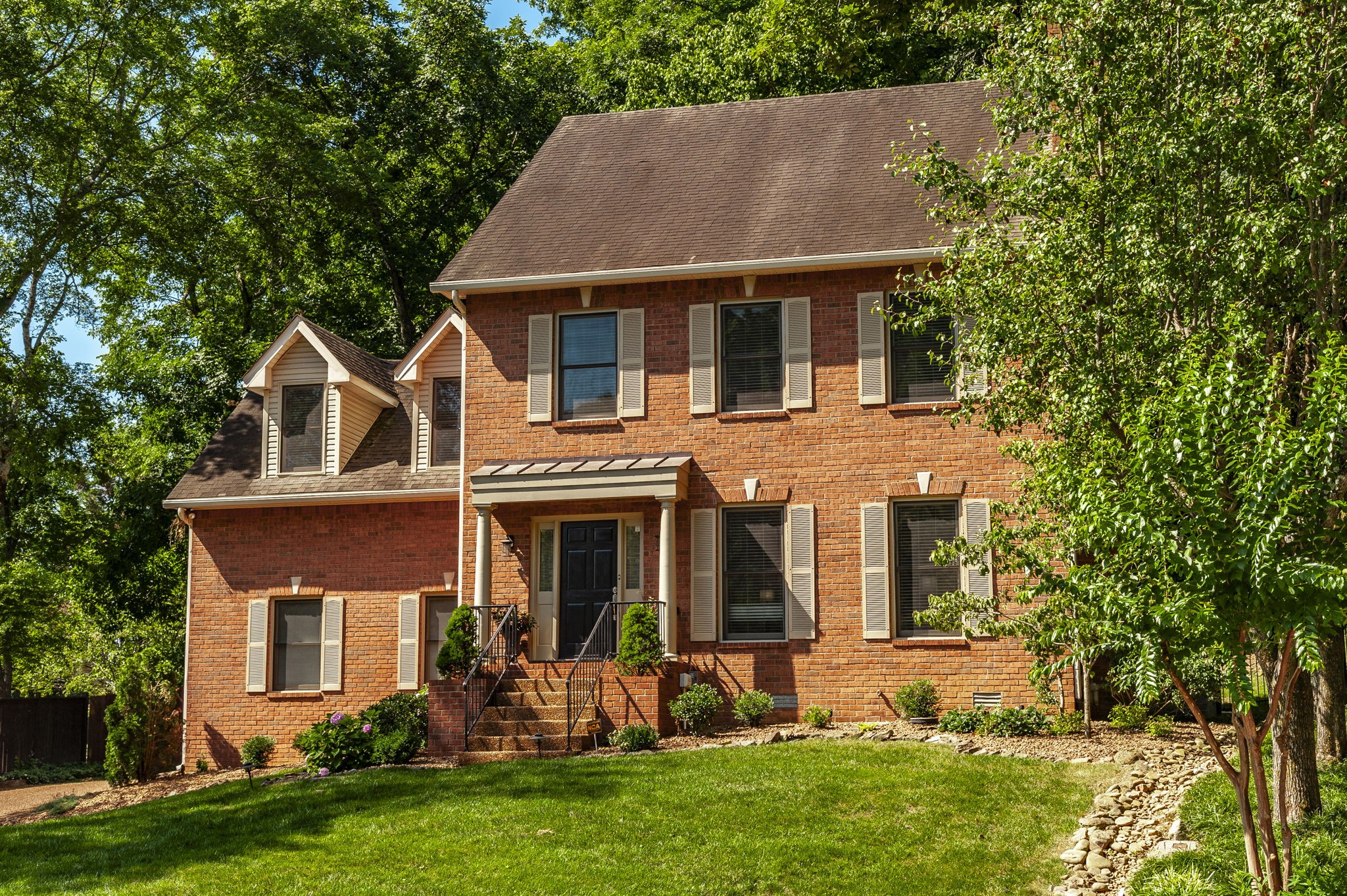 front view of a house with a yard