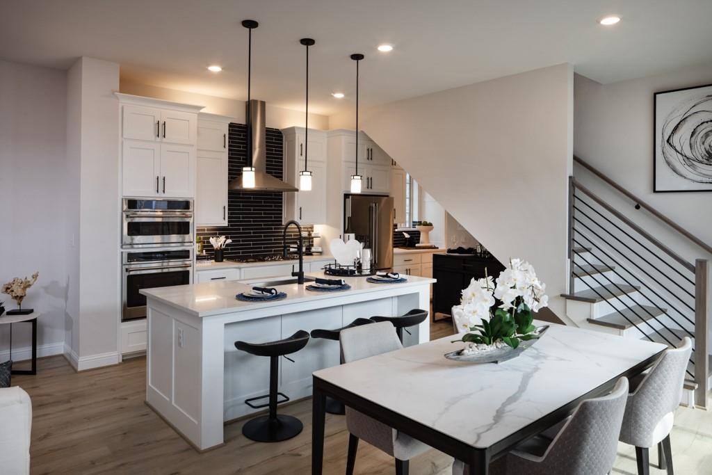 a kitchen with a table chairs stove and kitchen island