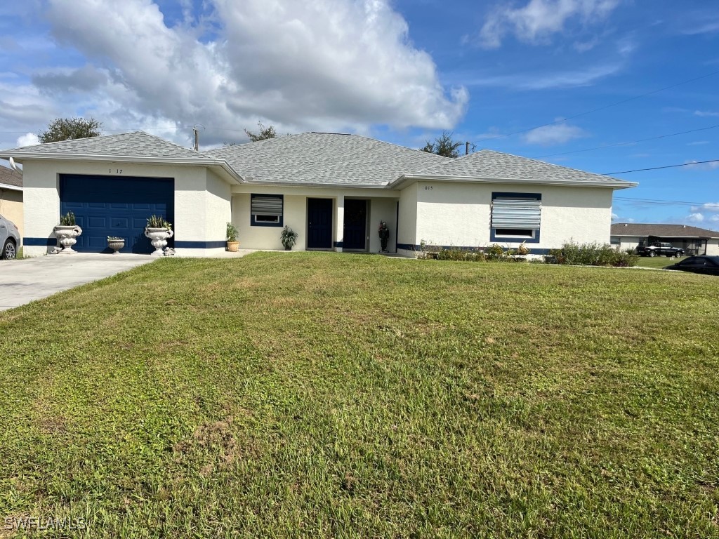 a view of a house with a yard and garage