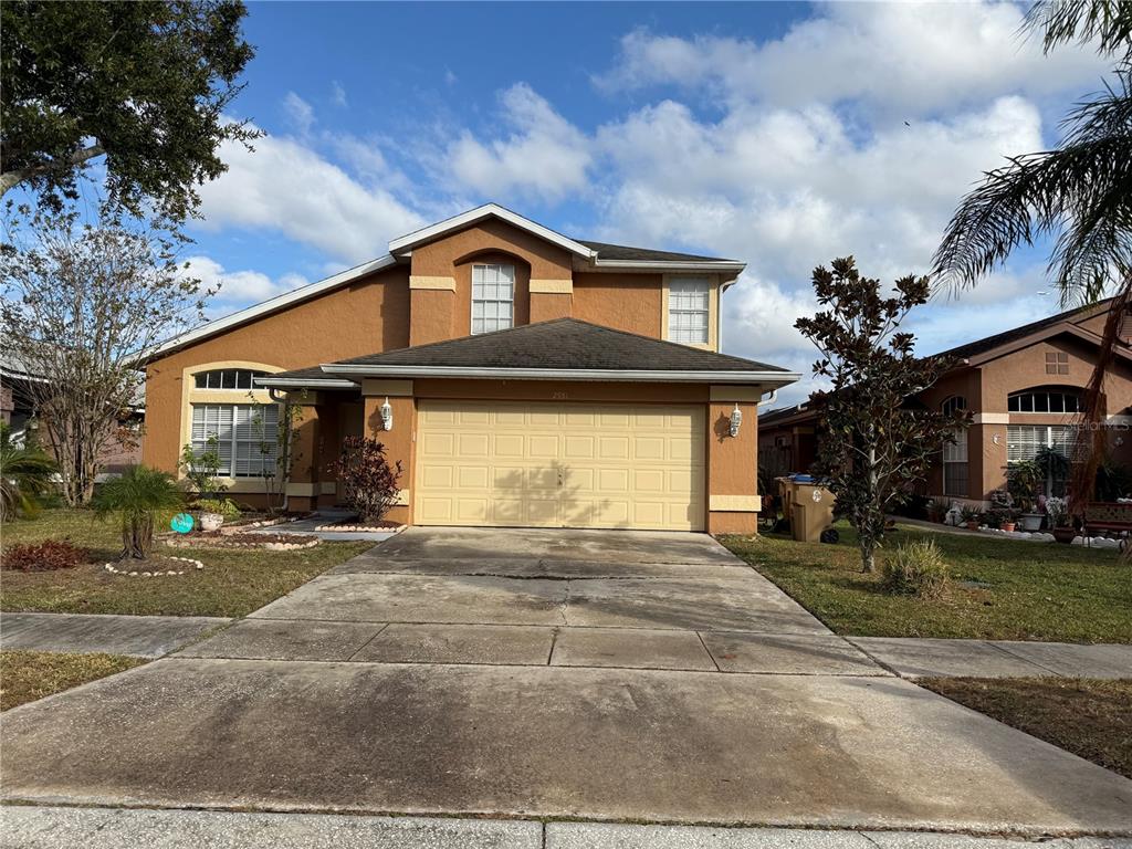 a front view of a house with a yard and garage