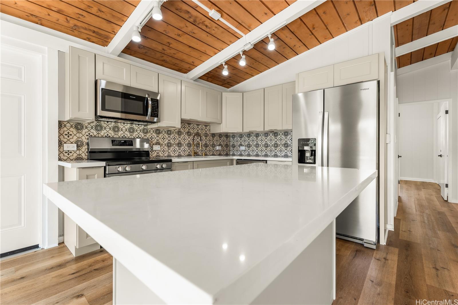 a kitchen with stainless steel appliances a refrigerator a stove a microwave and cabinets