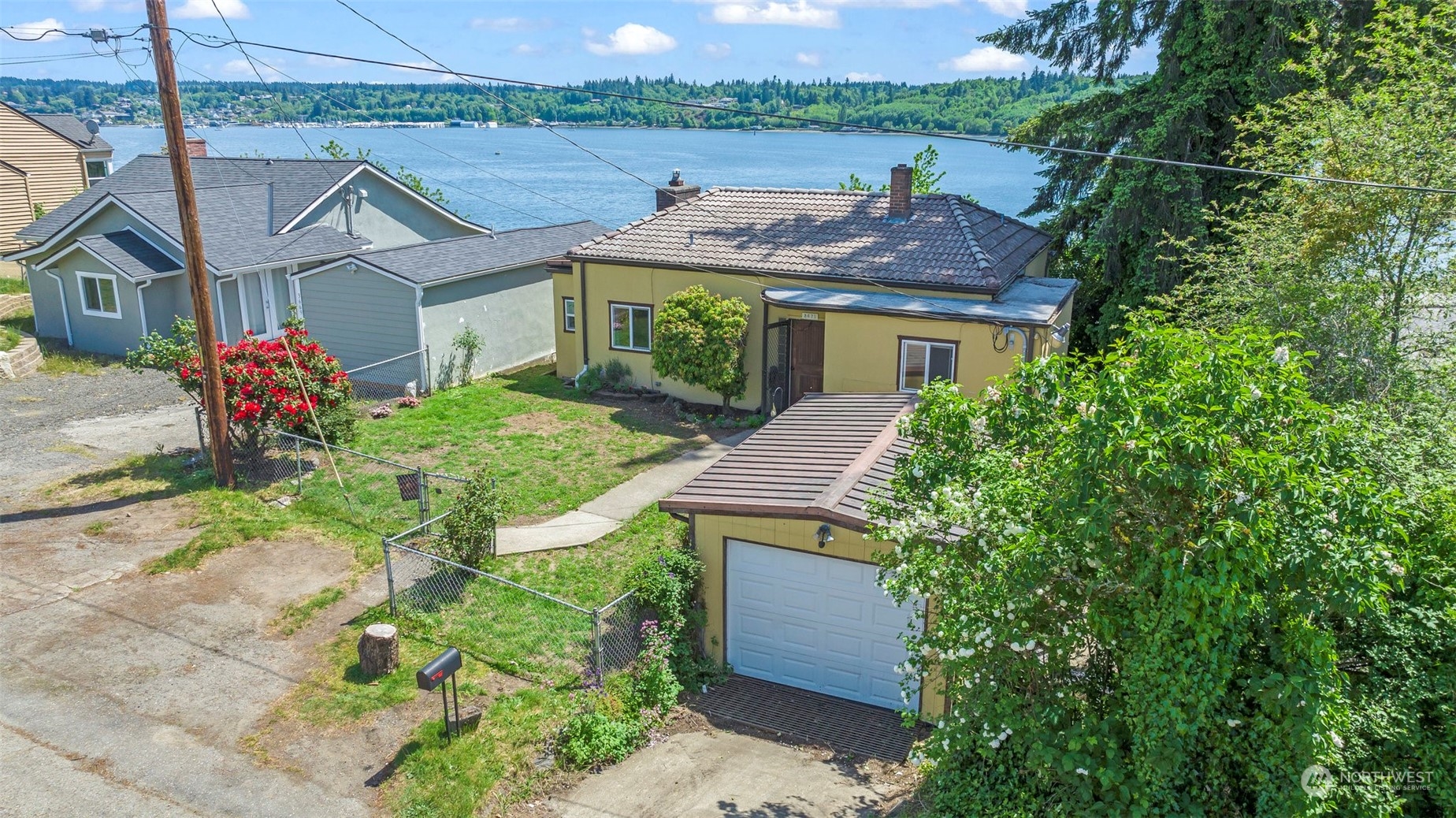 a aerial view of a house with a yard and potted plants