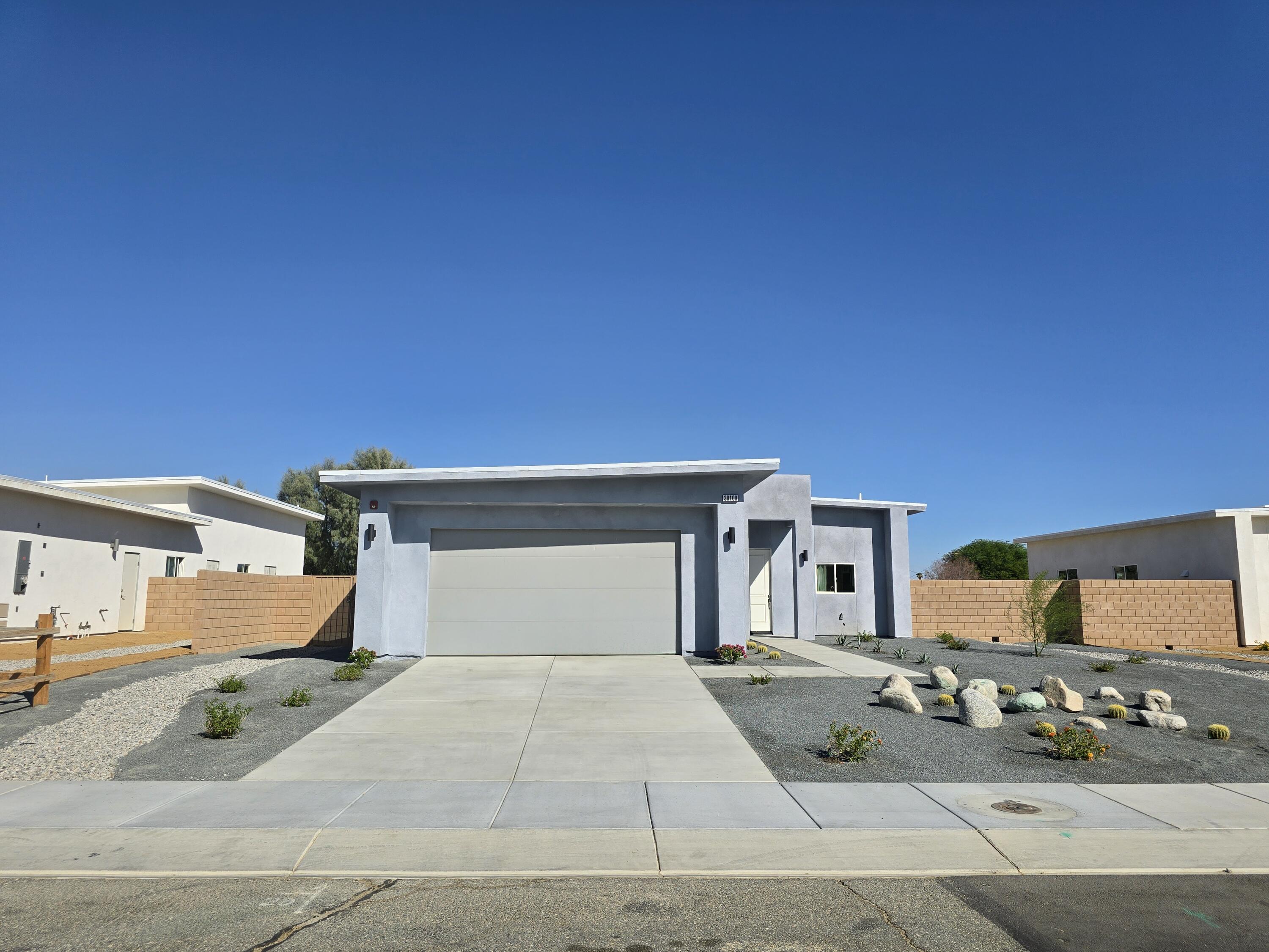 a front view of a house with garage