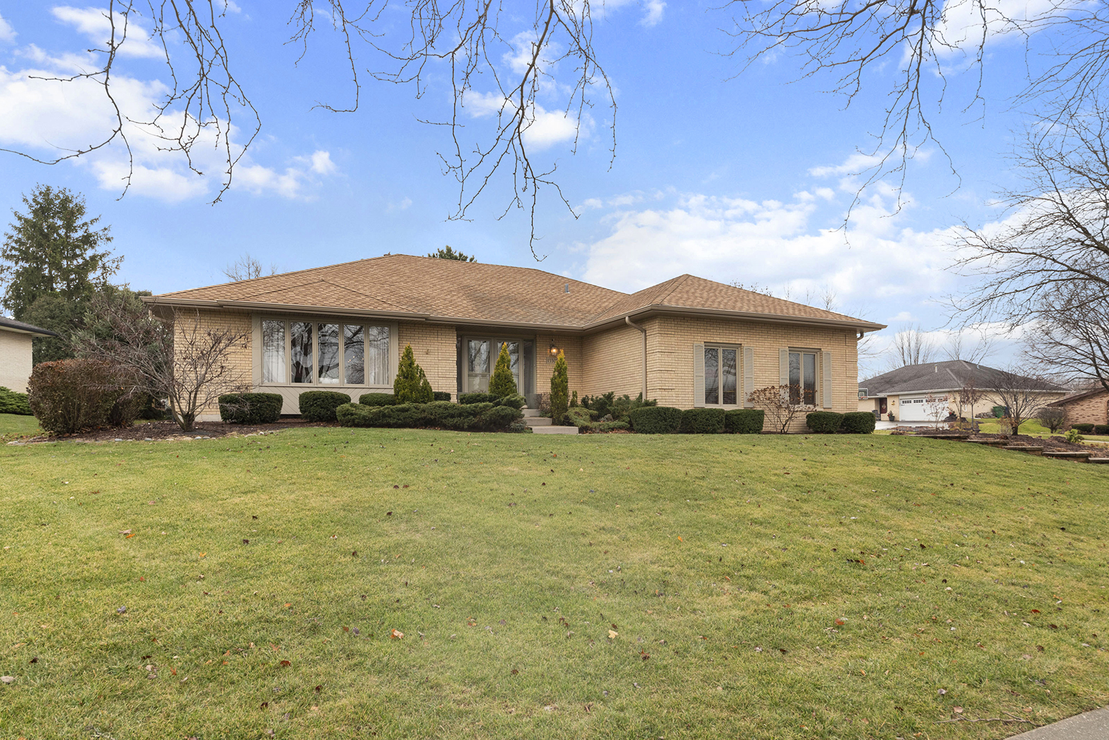 a front view of a house with a garden