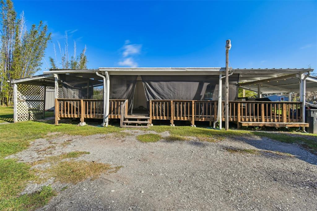 a view of a house with wooden fence next to a yard