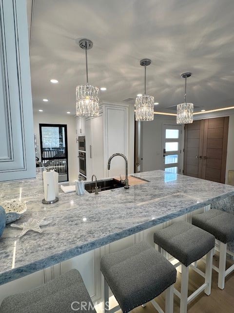 a view of a kitchen center island and stainless steel appliances