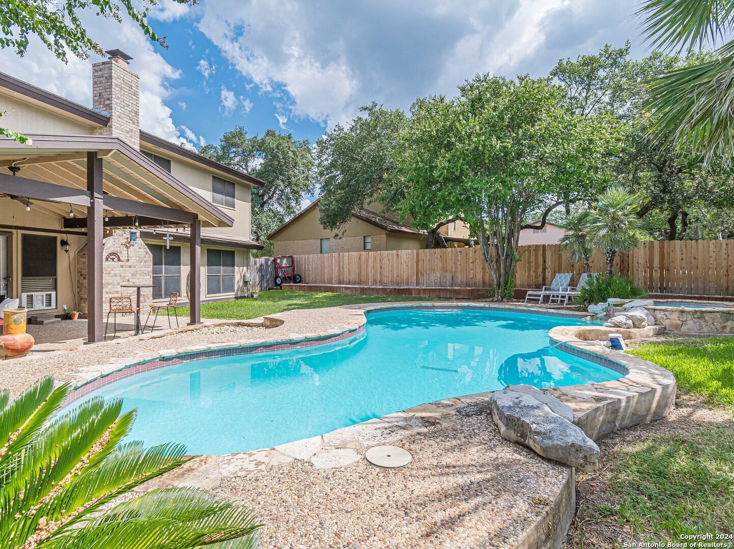 a view of a house with swimming pool and sitting area