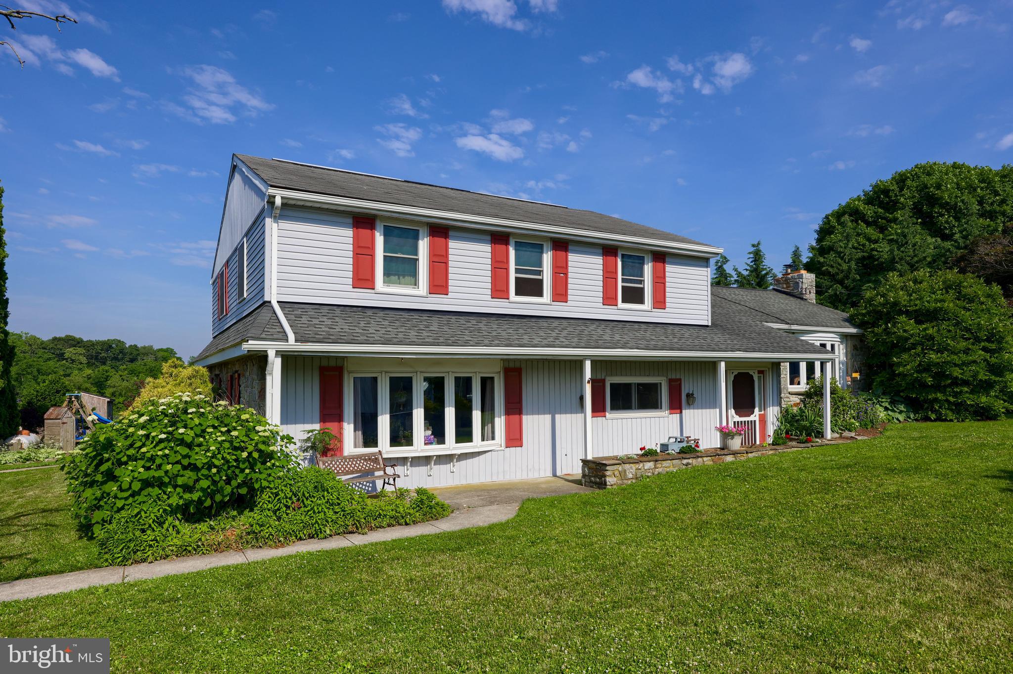 a front view of house with yard and green space