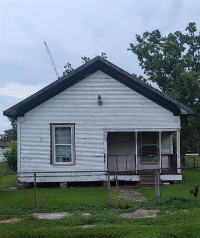 a front view of a house with a garden and yard