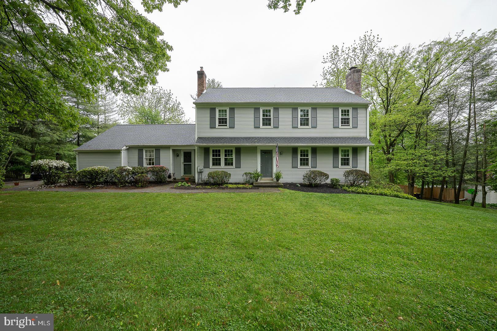 a front view of a house with a yard table and chairs