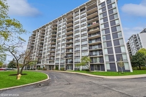 a view of a tall building next to a yard