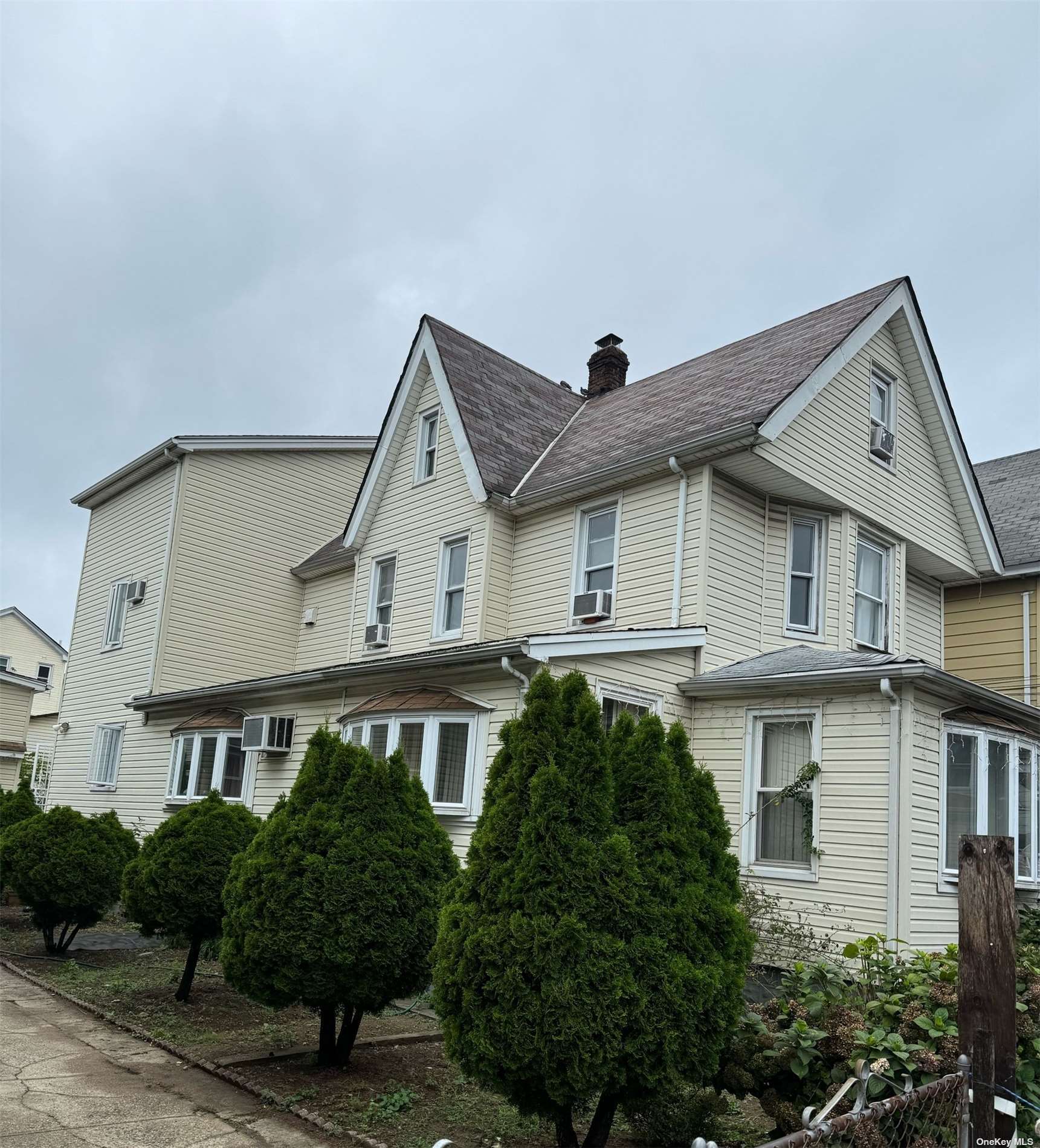 a front view of a house with plants