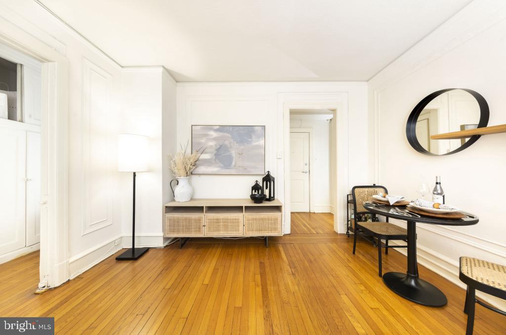 a view of a room with wooden floor and furniture