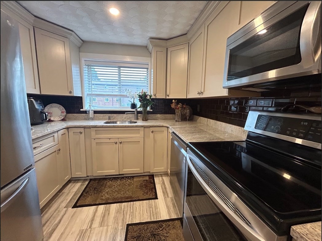 a kitchen with a sink stove and microwave