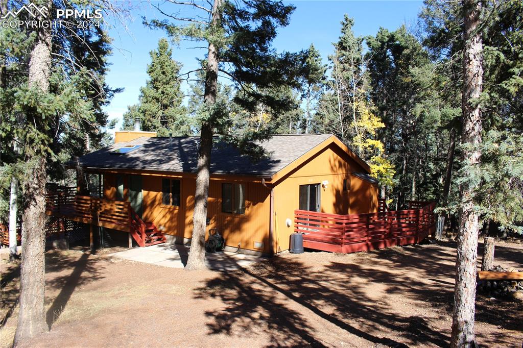 a front view of a house with a yard covered with snow and trees