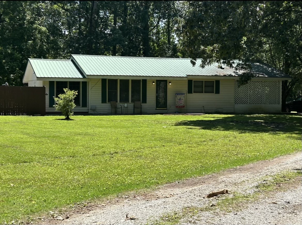 a view of a house with a yard and tree