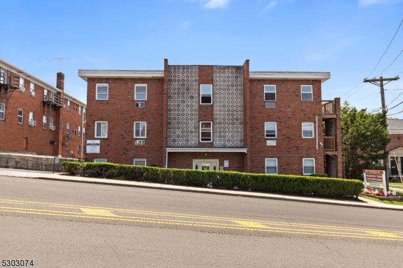 a view of a brick building next to a yard