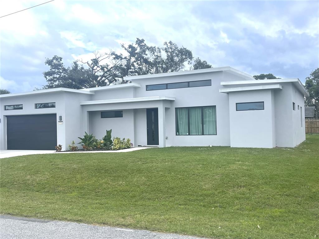 a view of a house with a yard and garage