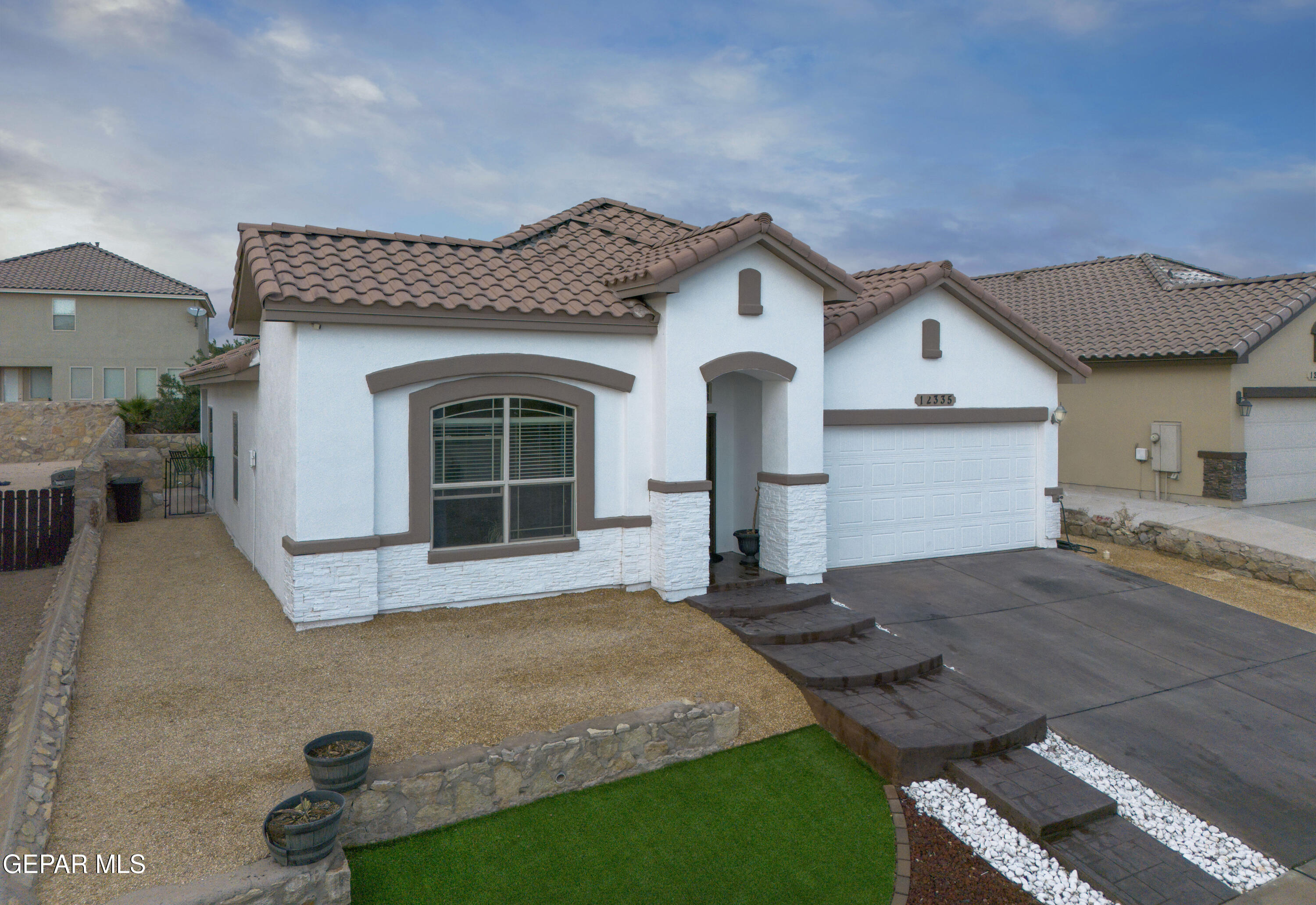 a front view of a house with garden