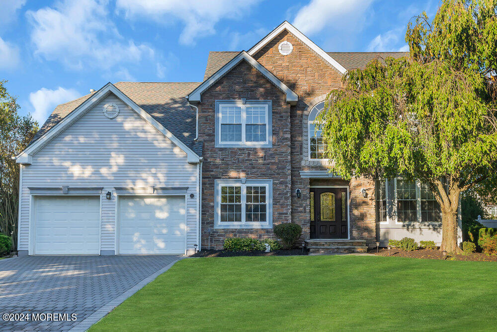 a front view of a house with a garden